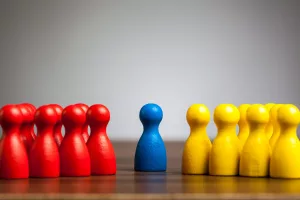 Symbolic Picture Of Mediation With A Neutral Figure Between Opposing Parties