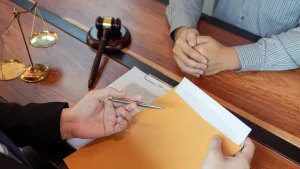 A Plaintiff Discussing Legal Documents With His Personal Injury Lawyer.