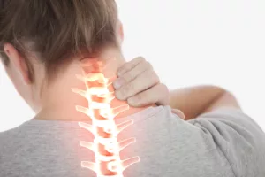 A Person Clutching Their Neck In Pain With A Highlighted Spine Illustration, Representing Pain And Suffering From A Personal Injury.