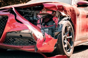 A Red Sedan’s Front Right End Is Crumpled And Smashed From A Collision, Illustrating The Need For A Desoto Car Accident Lawyer.