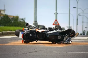 A Motorcycle Lies Wrecked In The Middle Of An Urban Intersection Following A Crash, Symbolizing The Types Of Cases A Cockrell Hill Motorcycle Accident Lawyer Handles For Injured Riders.