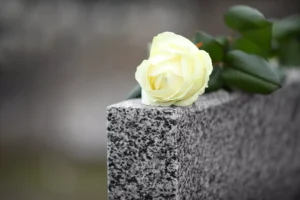 Yellow Rose Resting On A Gravestone, Symbolizing Loss And Support From A Cockrell Hill Wrongful Death Lawyer.