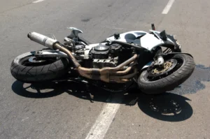 Damaged Motorcycle Lying On The Road After An Accident, Representing Cases Handled By A Desoto Motorcycle Accident Lawyer.
