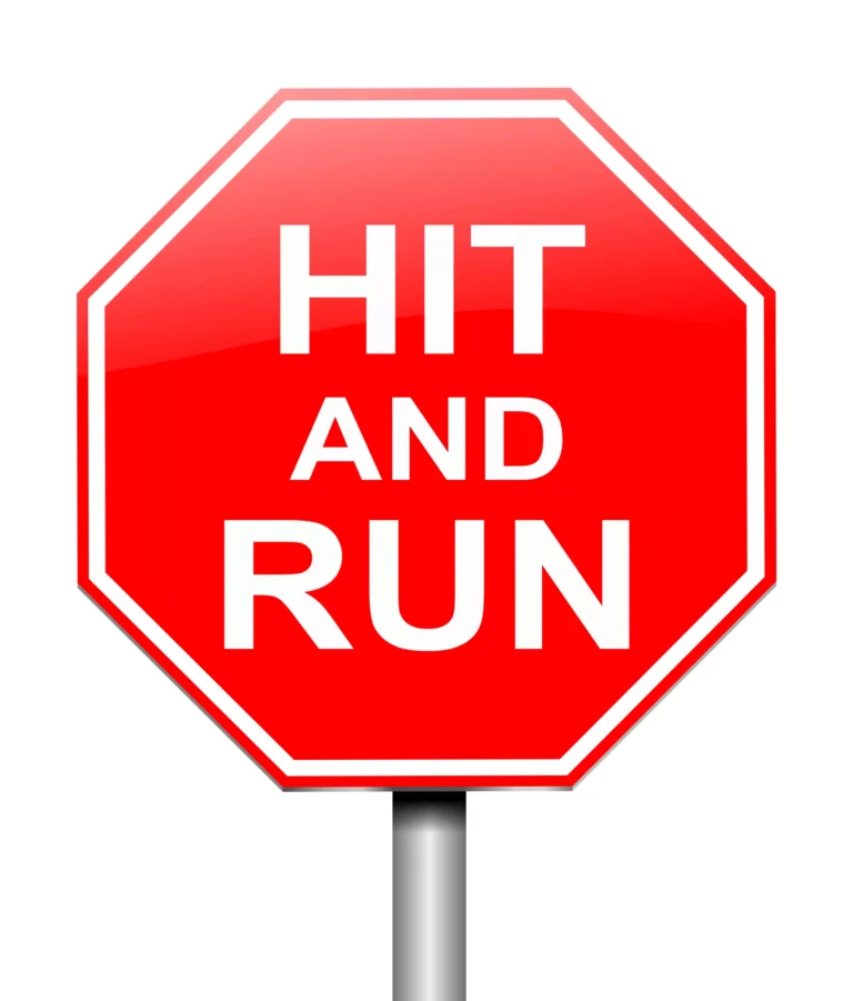 Red octagonal sign with bold white text that reads "HIT AND RUN," symbolizing the concept of a hit-and-run incident, representing the question does insurance cover a hit and run.