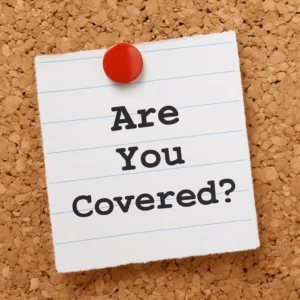 A Corkboard With A Note Pinned By A Red Pushpin Reading “Are You Covered?” Symbolizing The Question Of What Does Liability Insurance Cover.